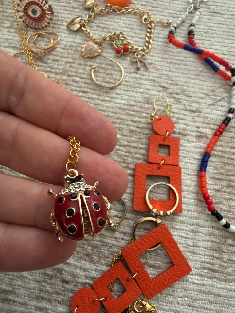 Gold-Tone Jewelry Set with Orange Statement Earrings and Red Ladybug Pendant